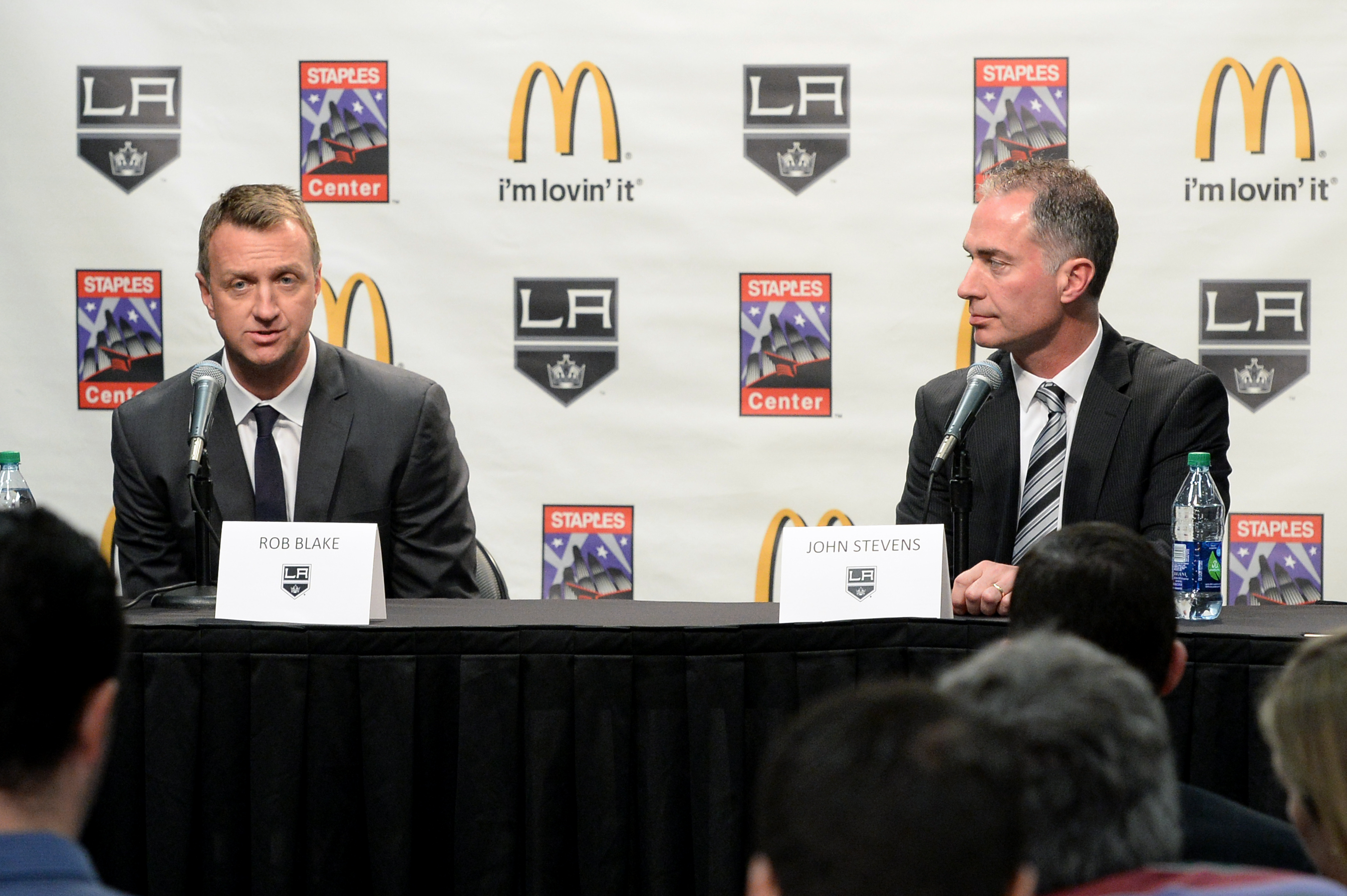 Image of Rob Blake and John Stevens at a LA Kings press conference with a LA Kings and McDonalds step and repeat behind them