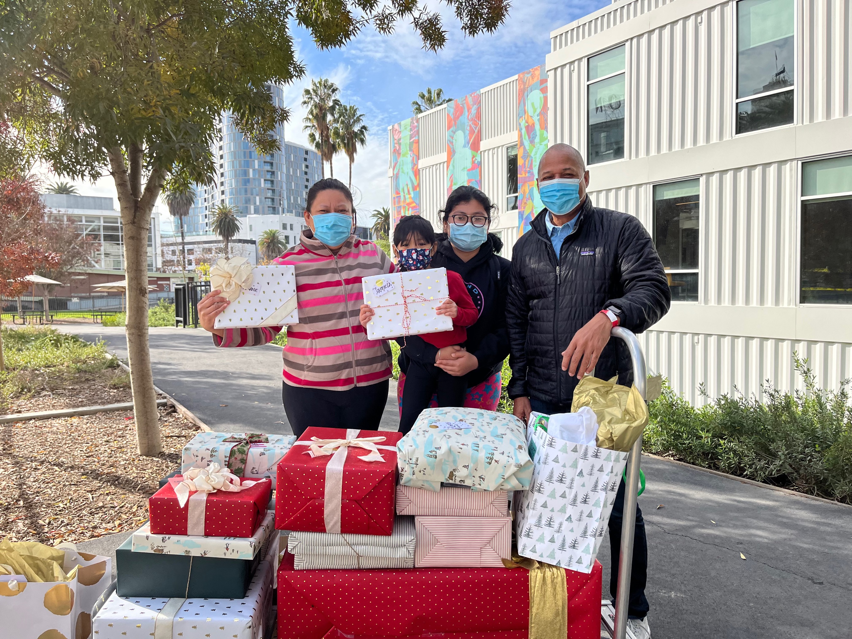 A family receives a wagon full of presents for the Adopt A Family program