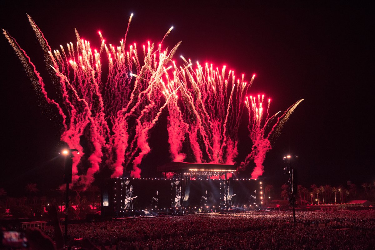 Image of the stage at night with red fireworks coming out the top at Desert Trip in Indio