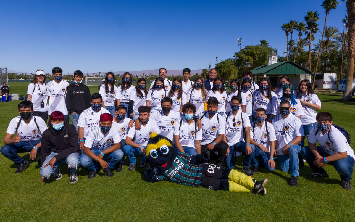 Students pose with Cozmo during the LA Galaxy Coachella Invitational. 
