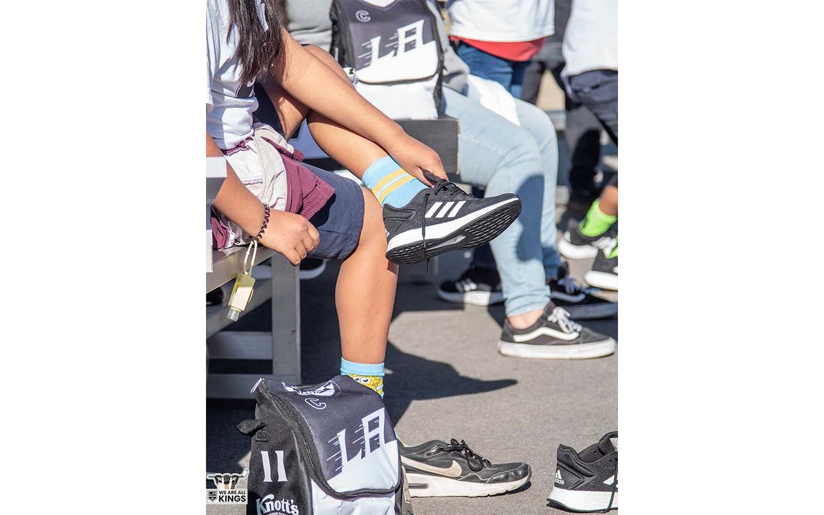 A student tries on new adidas sneakers during the LA Kings Shoes That Fit event at an elementary school in Compton, Calif.