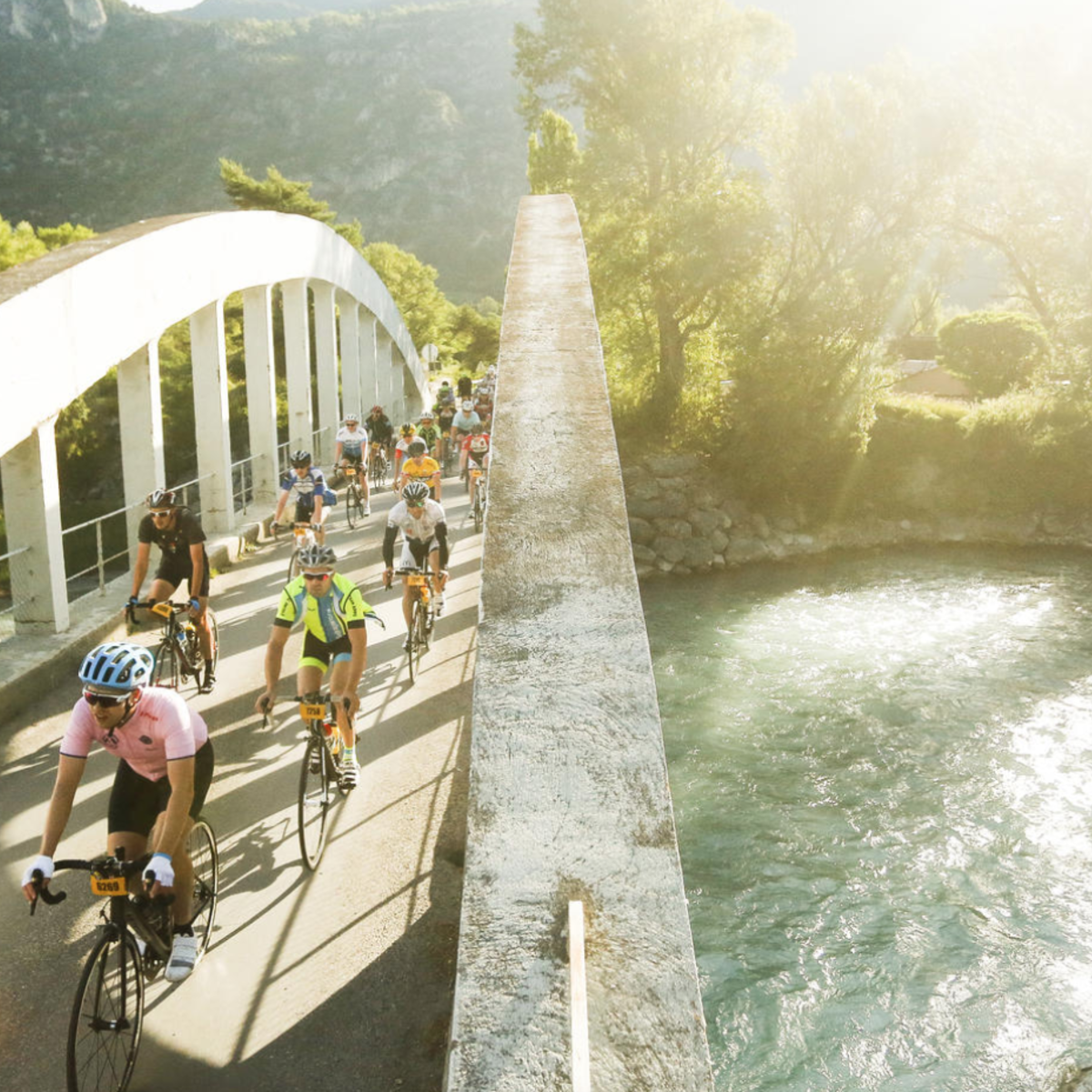 Riders biking over a bridge