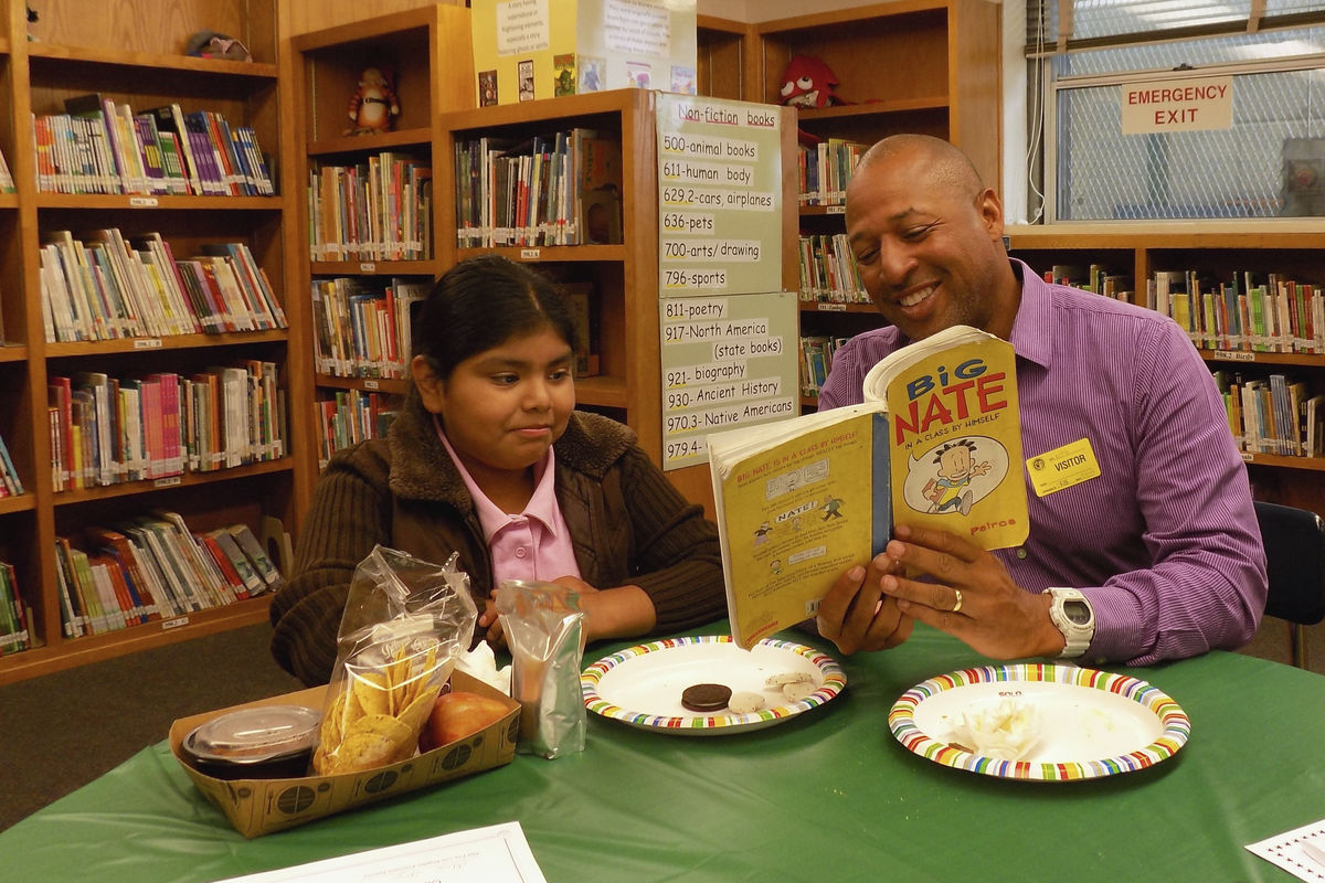 employee reading a book to a child