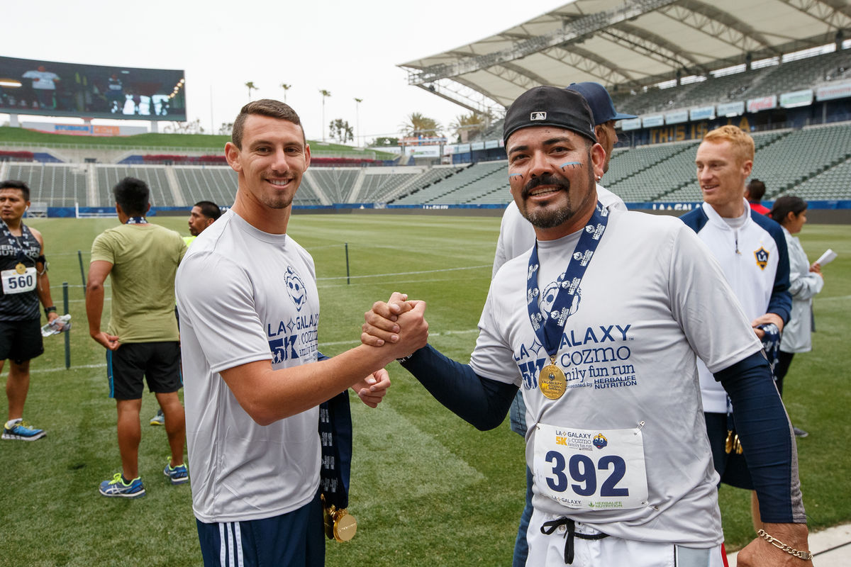 LA Galaxy defender Daniel Steres congratulates a runner following the Annual LA Galaxy 5K and Cozmo Family Fun Run at StubHub Center in 2016.