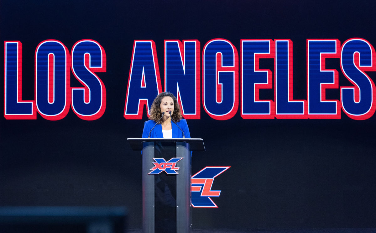 StubHub Center General Manager Katie Pandolfo addresses a group from the podium at a press conference for XFL. 