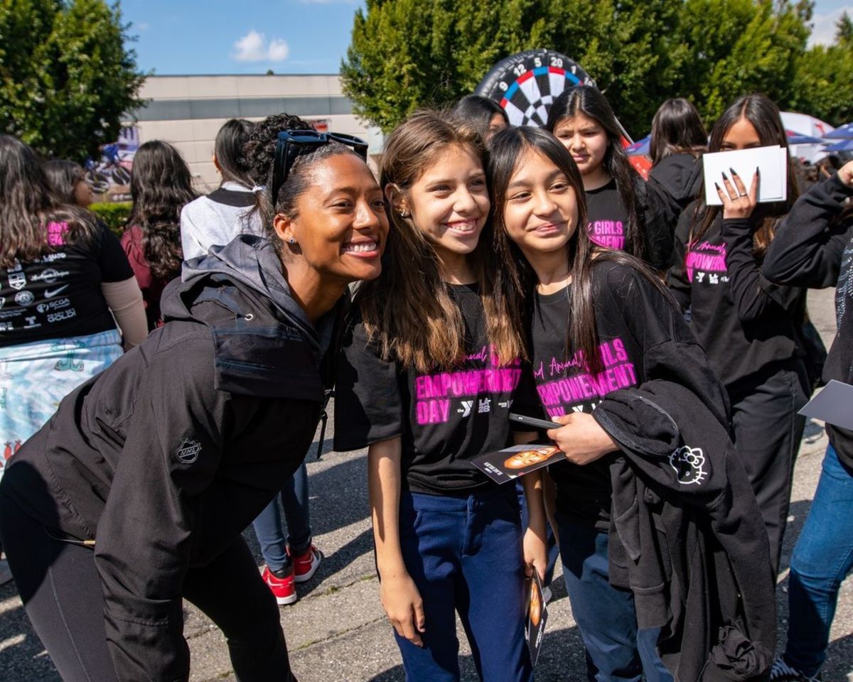 Blake Bolden poses with students at Girls Empowerment Day.