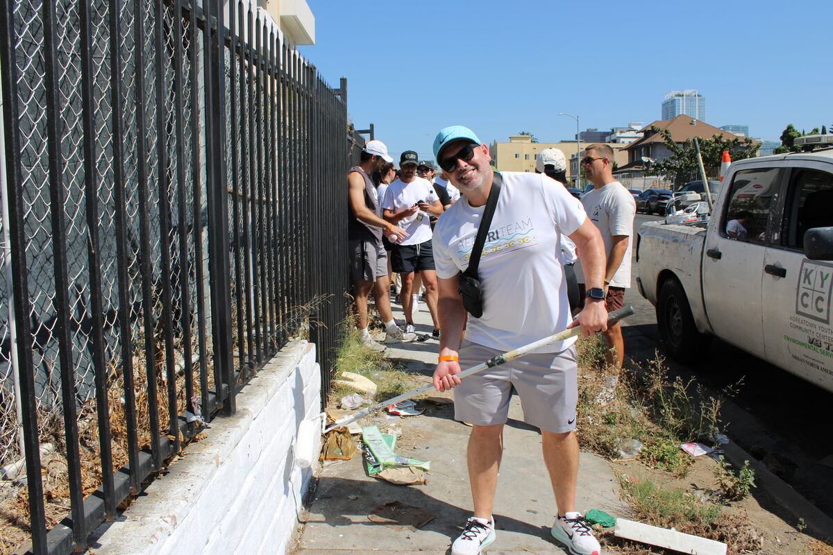 Volunteer removing graffiti with white paint in Koreatown