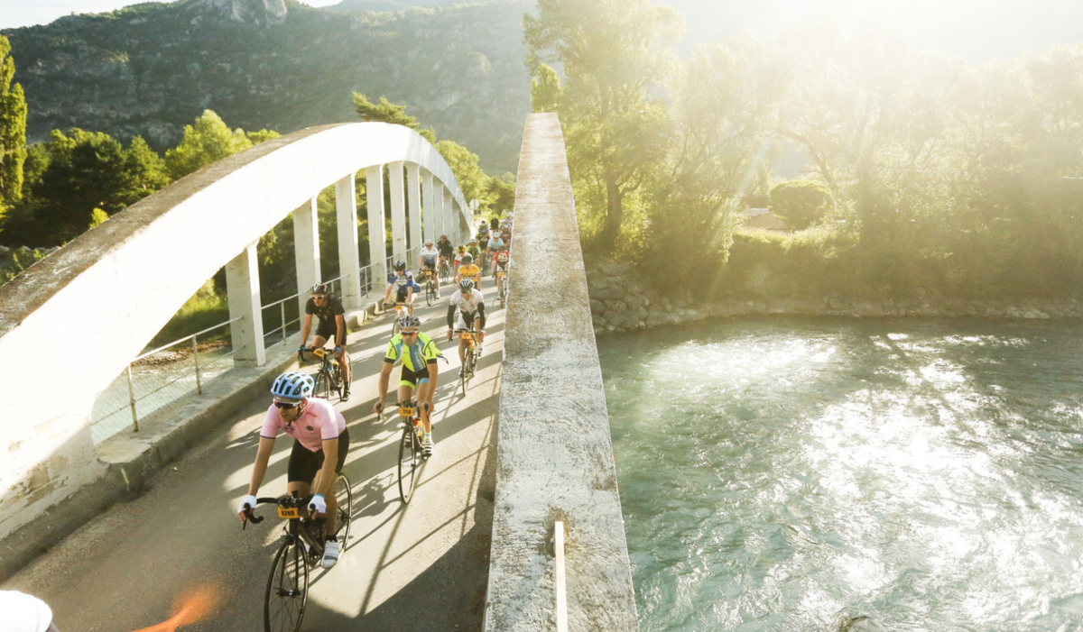 Riders biking over a bridge