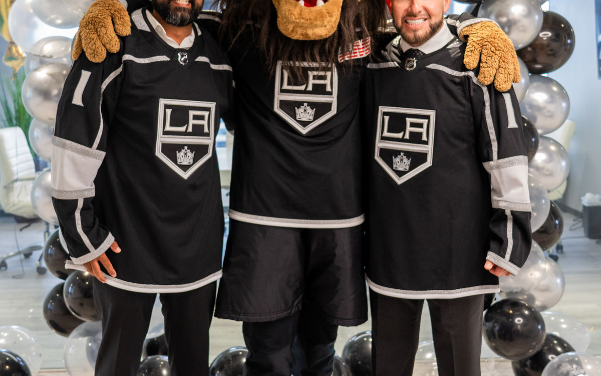 CD LAW partners and co-founders Vineet Dubey and Miguel Custodio are joined by LA Kings mascot Bailey to celebrate CD LAW's new 